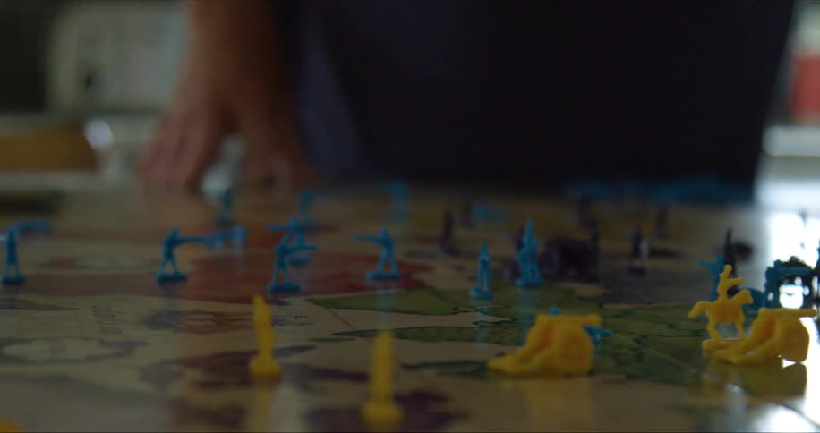 A man and woman play a board game together