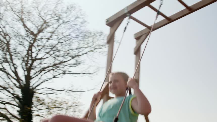 A girl swings on the swing in the playground
