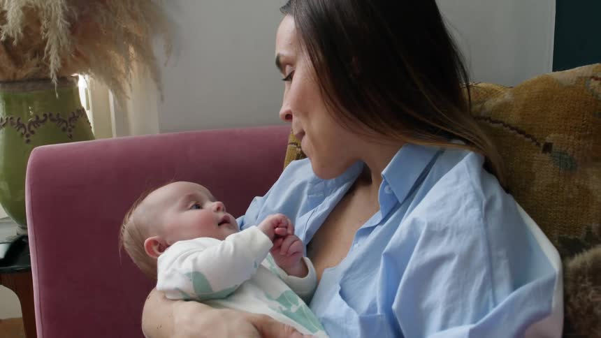Mother singing to newborn baby