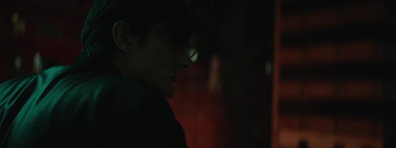 A man is outdoors in an urban city at night