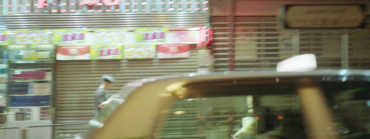 The pedestrians and traffic along a busy streets of a metropolis at night