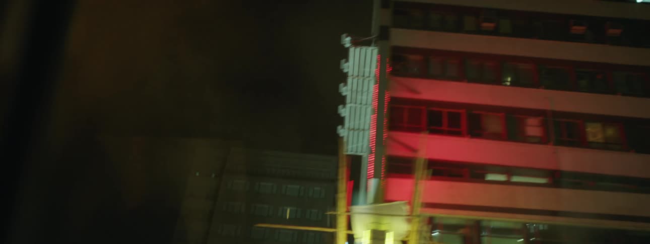 Buildings in a city sit in the night