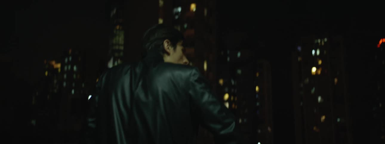 A man is walking in a building in a downtown city