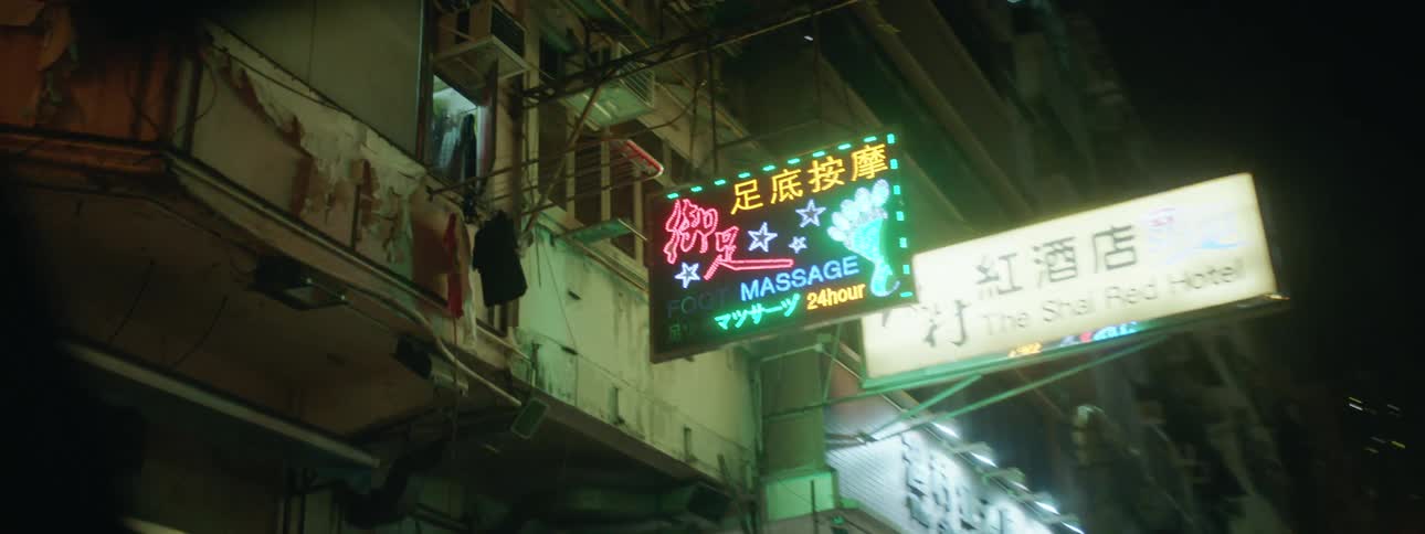 A vehicle windshield showing the city in the foreground