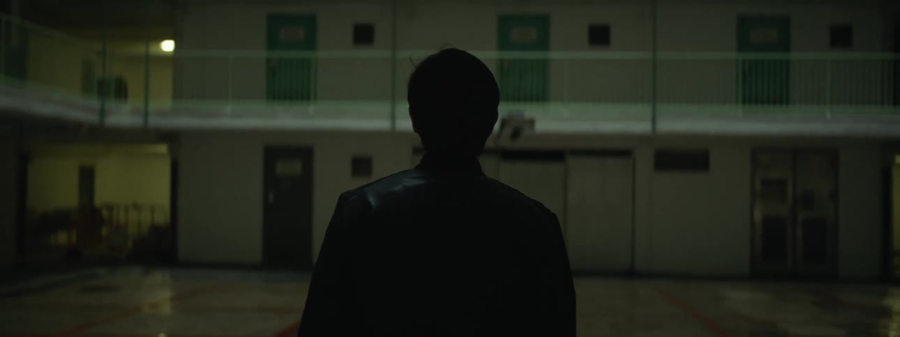 A man walks towards a building