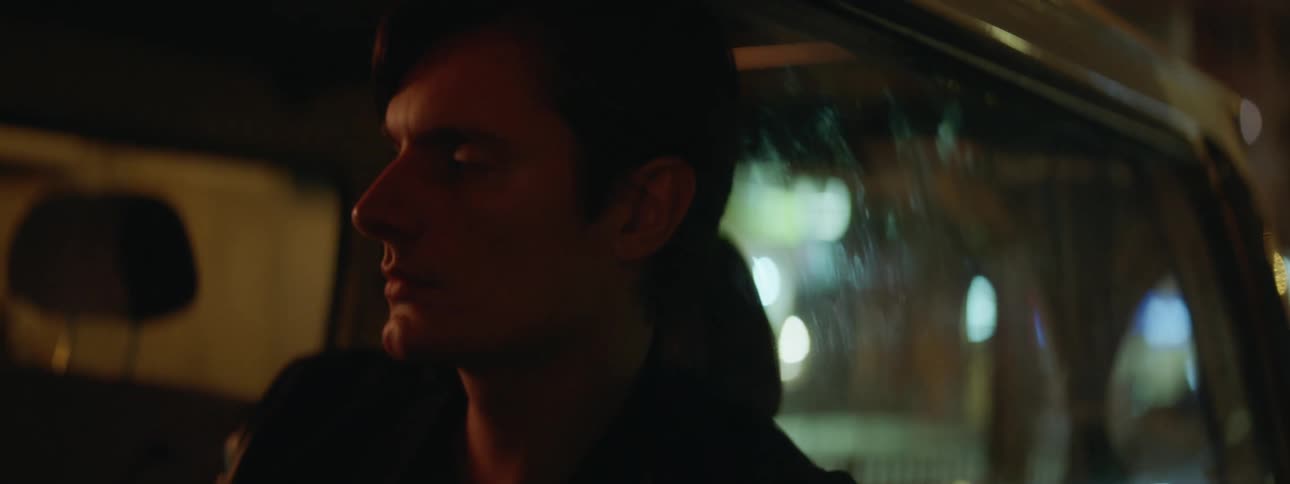 A man sits in the car waiting