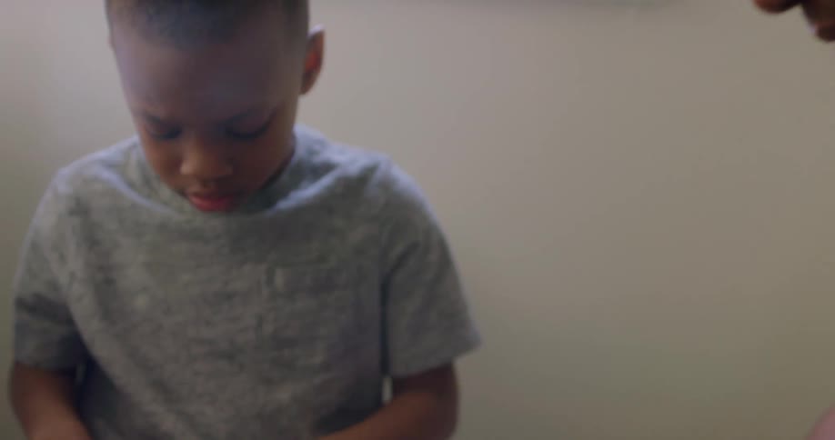 Father high fives young son while putting together toy