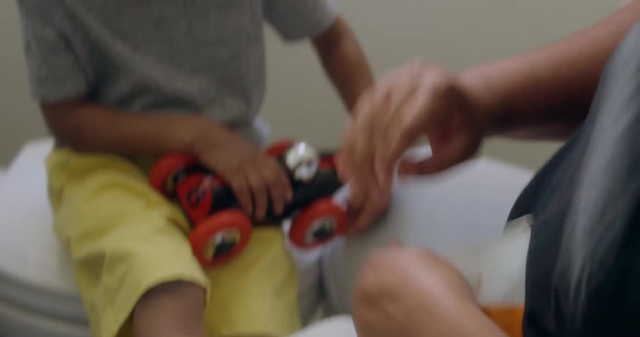A man puts a bandaid on a child