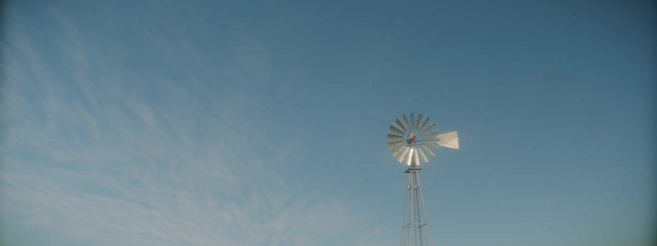 A windmill is displayed in a rural area