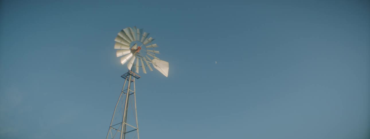 A windmill sits still outdoors