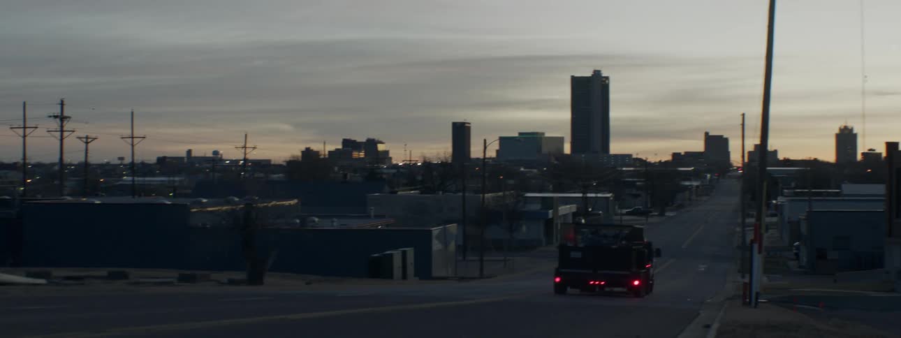 Cars and trucks drive through a city
