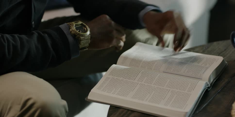 A person flips the page studying a book
