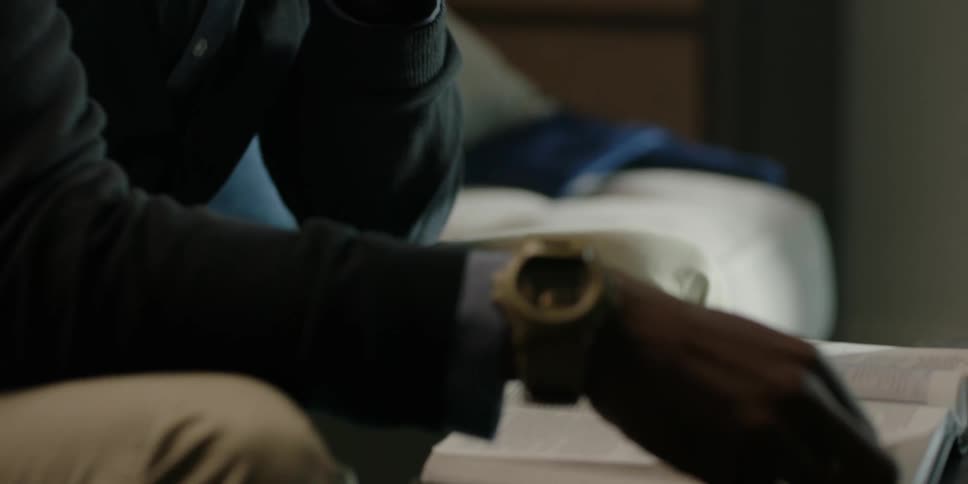 A man is studying a book in his living room
