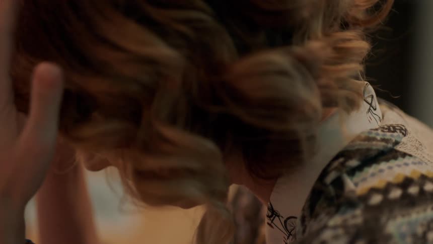 Woman talks to herself while nervously patting her head with her hands