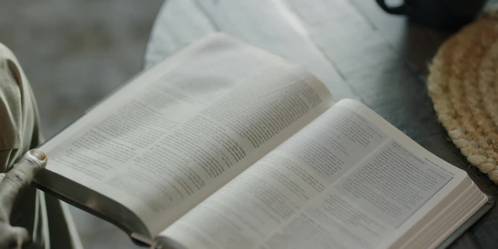 Black man turns over the pages of a book