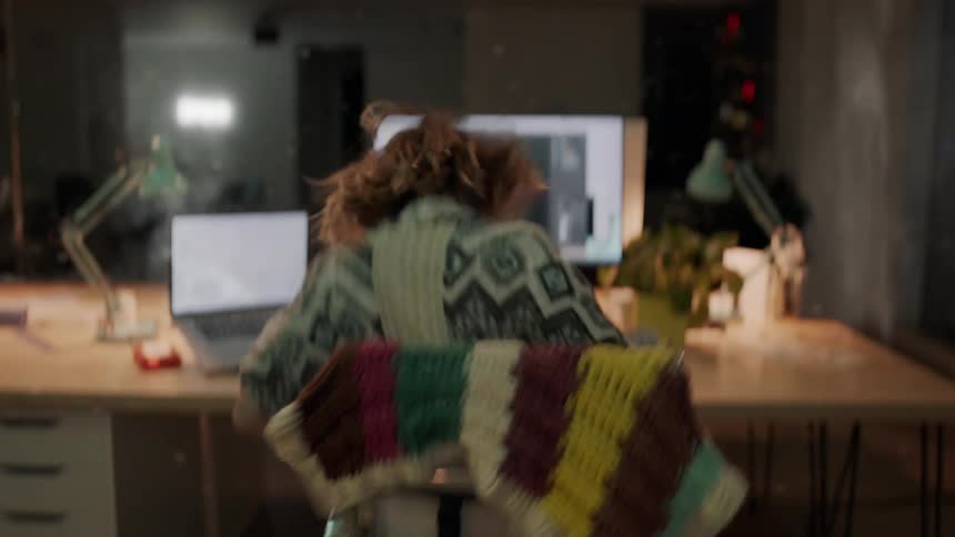 A woman sits in her chair thats bouncing from an earthquake