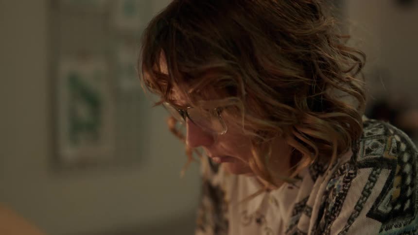 A woman looks up at smoke falling down