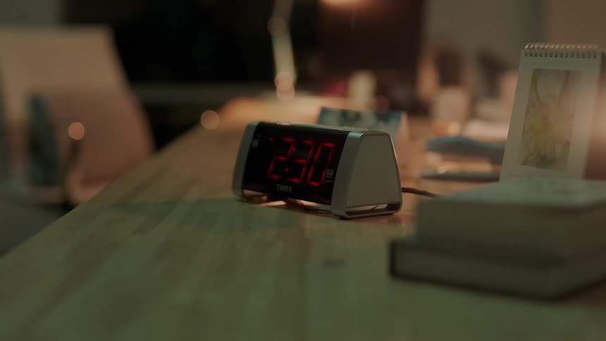 A golf club smashes a digital alarm clock