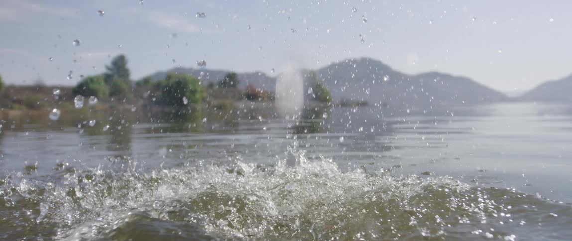 A large rock being thrown in to water
