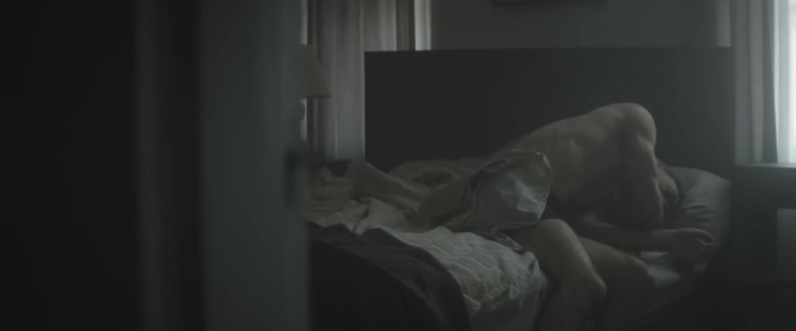 A man slowly gets up out of bed