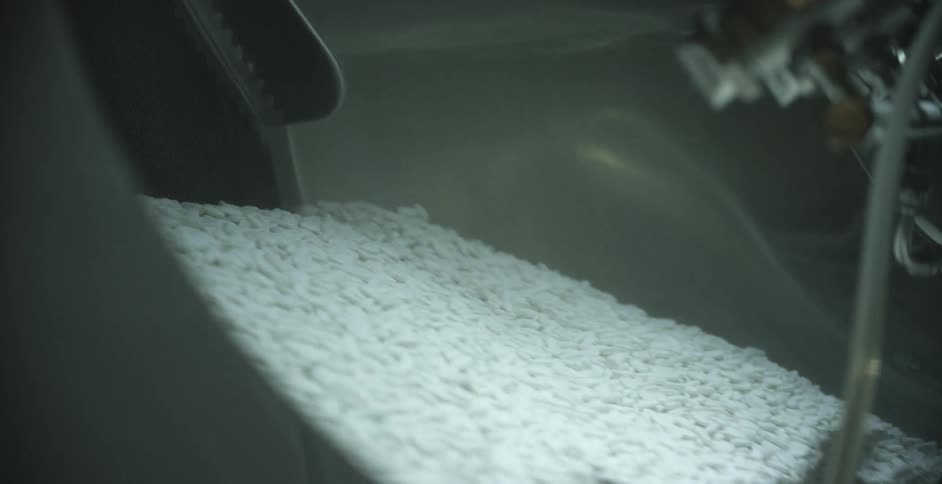 Rice moving down a shoot in a factory