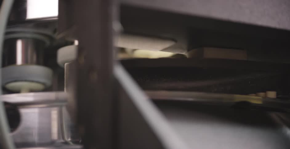 A machine on an assembly line moves through its motions