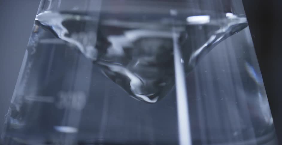 Liquid being mixed inside a flask on laboratory