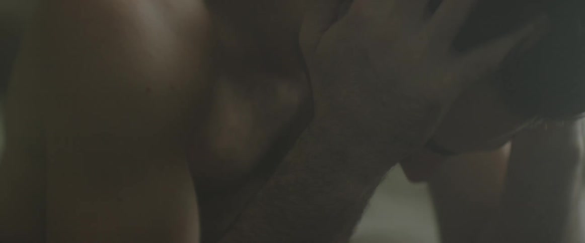 A man leans forward with his head in his hands