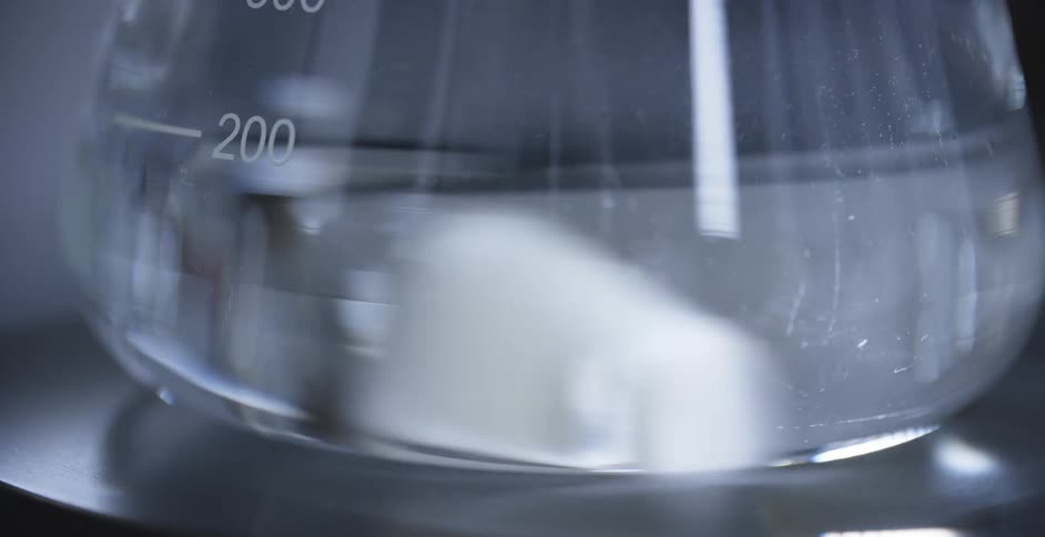 Clear liquid stored in glass container with measure marks