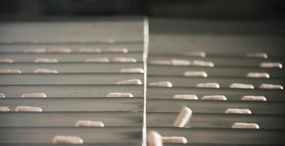 The pills move down the conveyor belt