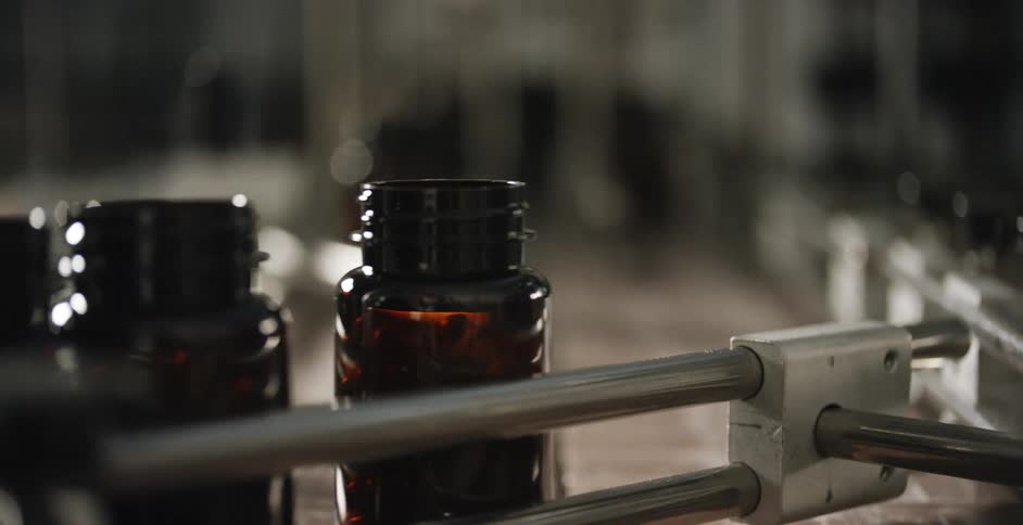 Glass bottles for medicines on a conveyor belt