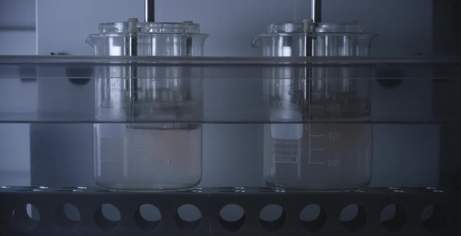 Liquid in beakers with plungers being inserted