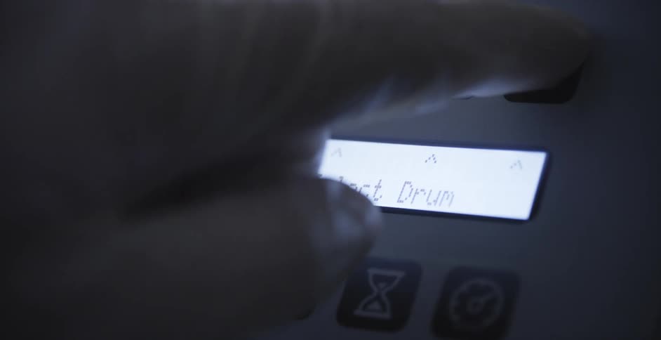 A person is pressing a button on a machine