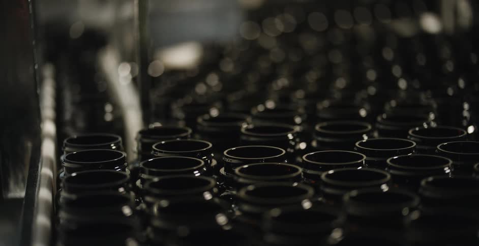 Bottles move along a belt on an assembly line