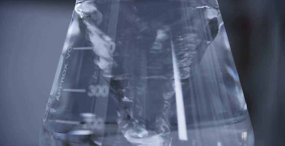 A beaker with water spinning in it is displayed