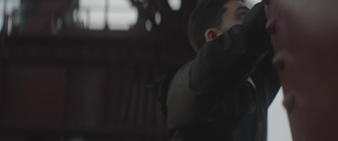A man climbs up a wall indoors