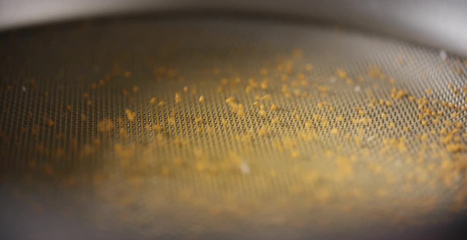 Grain on a mesh sieve in a factory