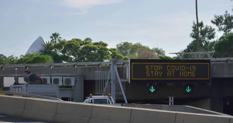 Traffic sign reads stop covid19 stay at home on the street