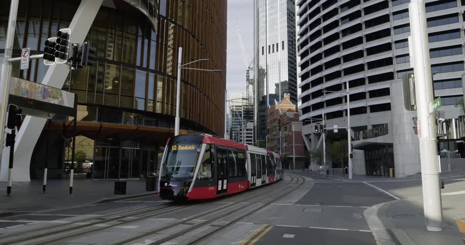 Tram goes along metal tracks in the road