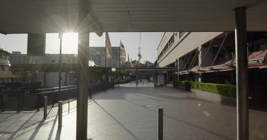 A transportation station gives way to a wide walkway through a downtown area