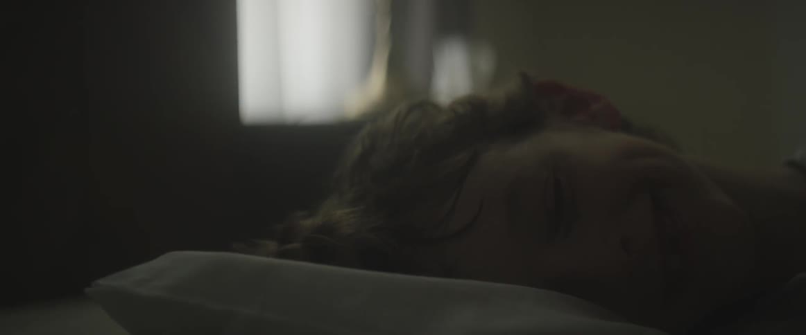 A young boy restlessly moves in his bed at daybreak