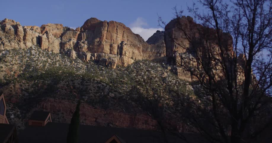 A building at the base of a large canyon