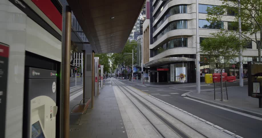 A light rail station on a street in a metropolis