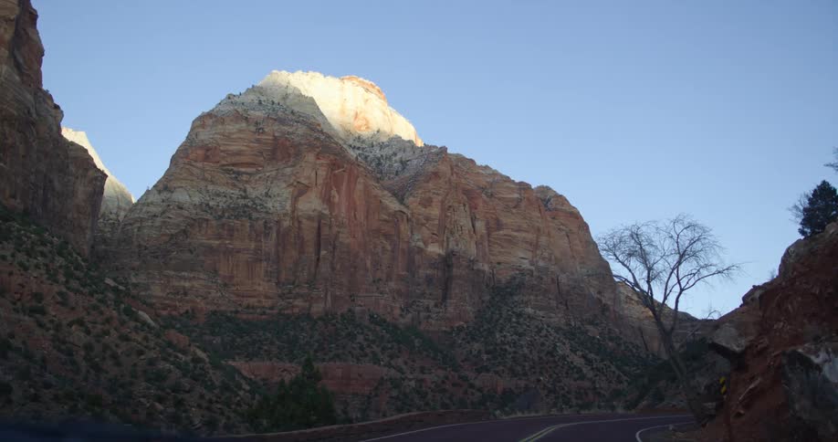 A road in a canyon with a plateau in the foreground