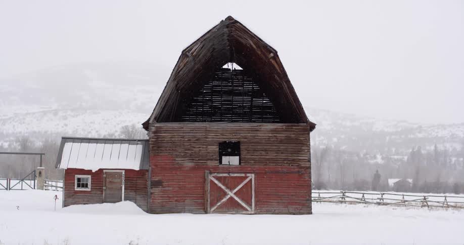 A barn on a snow covered field