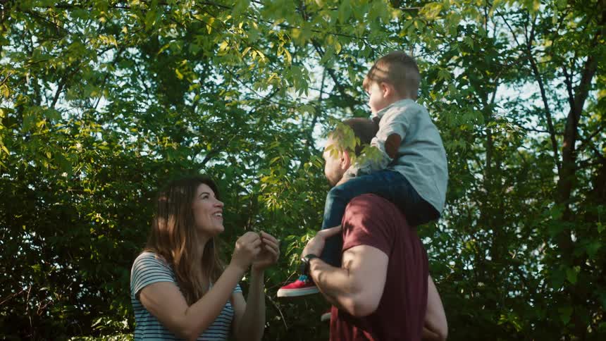 A family enjoy themselves by the trees