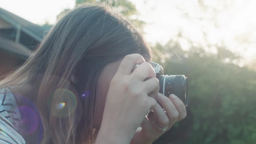Woman takes pictures of her family in the garden