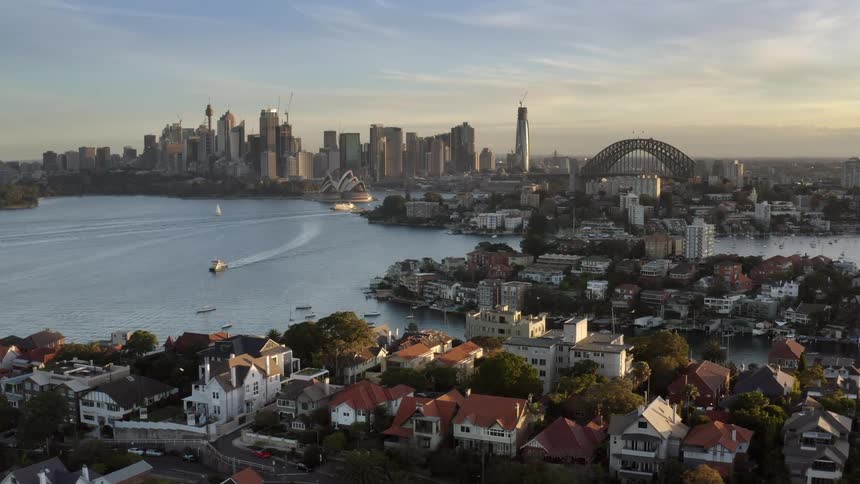 An ocean is surrounded by densely packed neighborhoods and a city