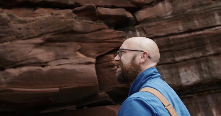 A man looking around at an escarpment in the badlands