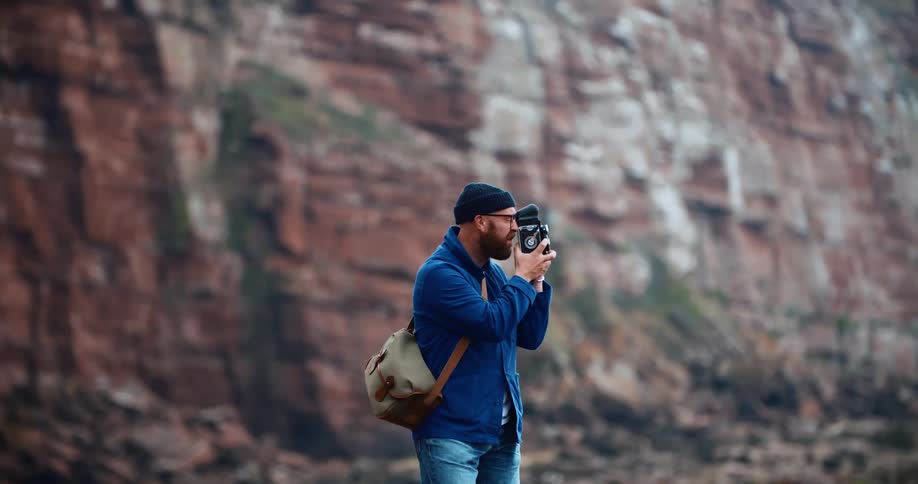 Male photographer takes a picture in the canyons